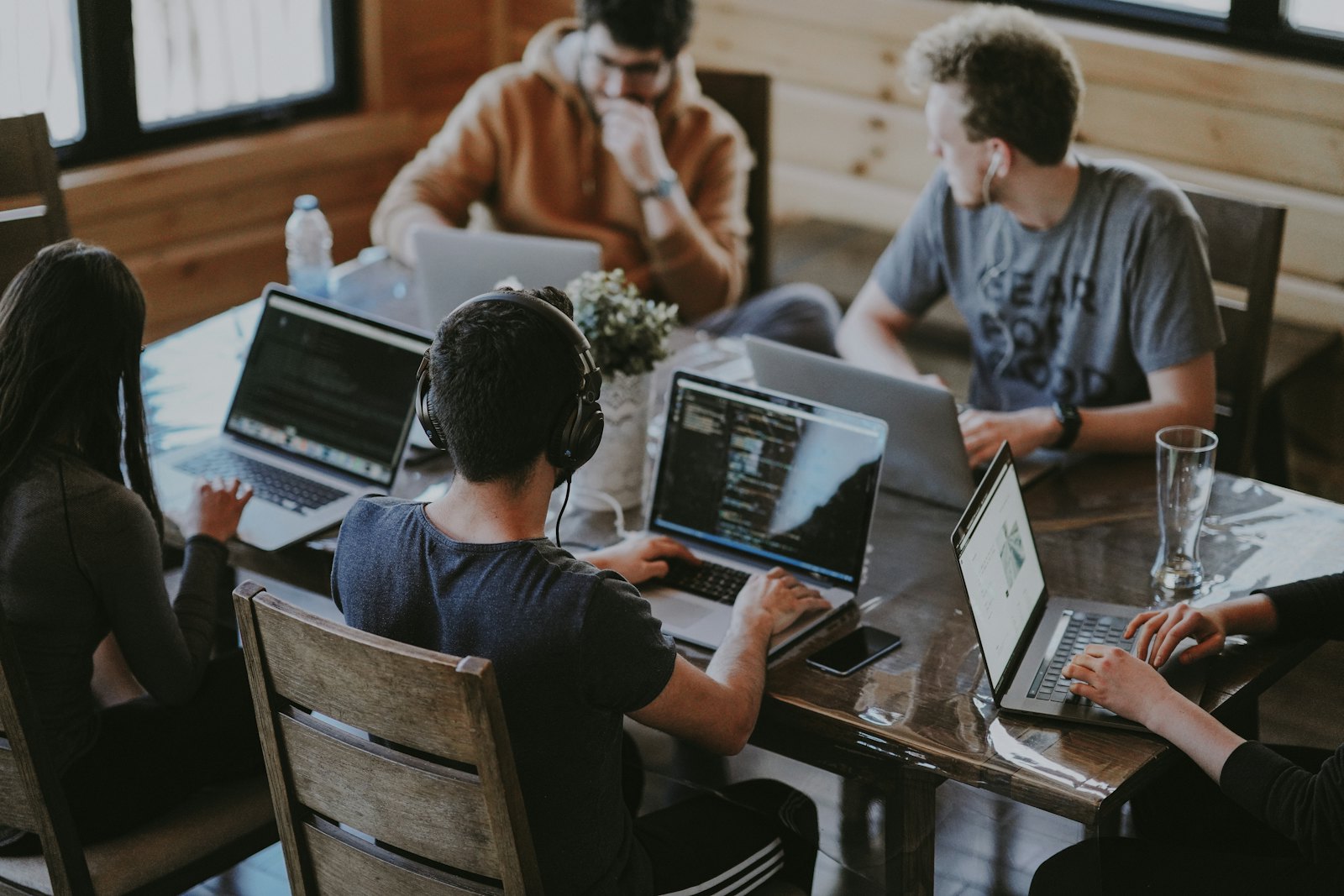 A small group reviewing a document around a laptop