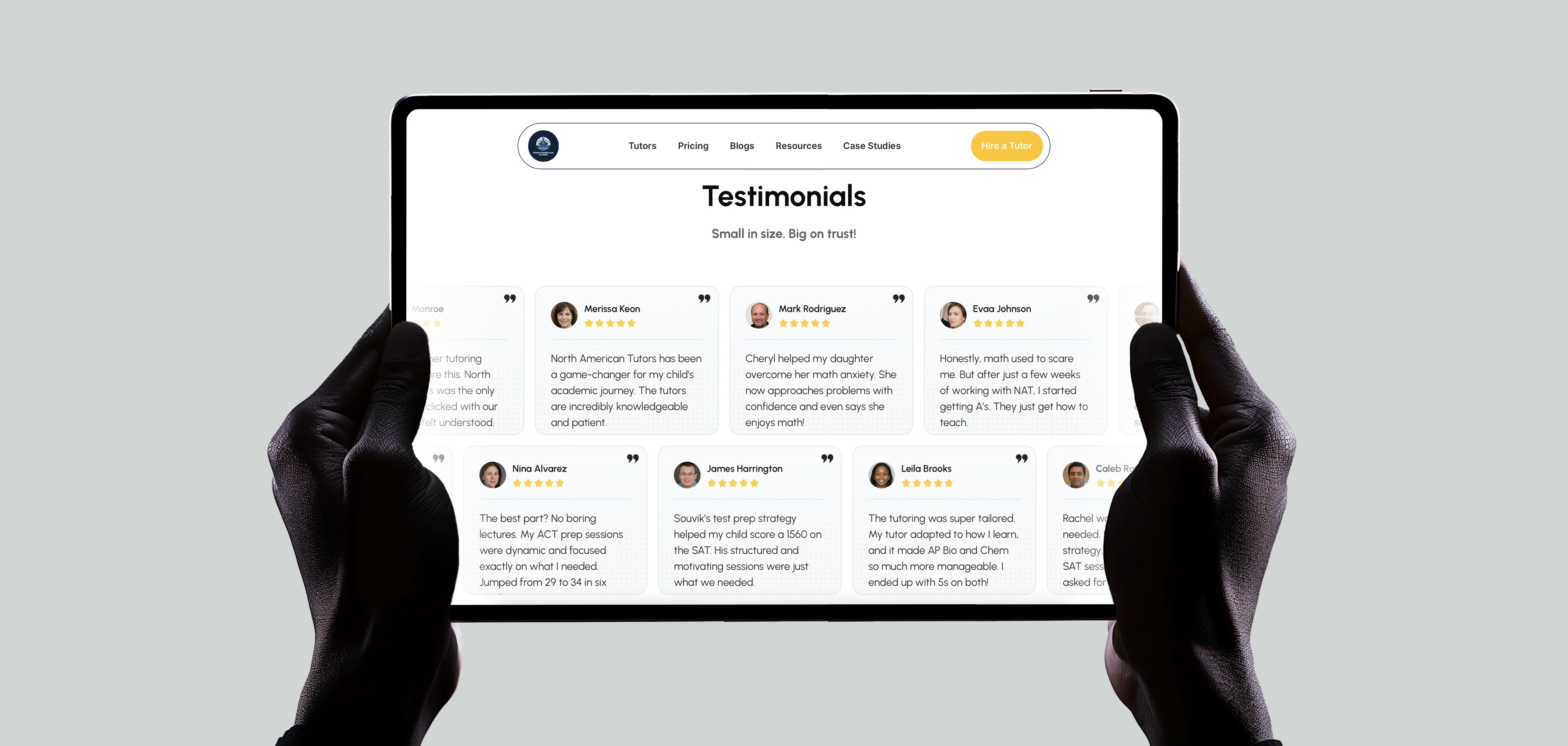 The testimonial wall on a tablet held in two hands, named reviews with score jumps