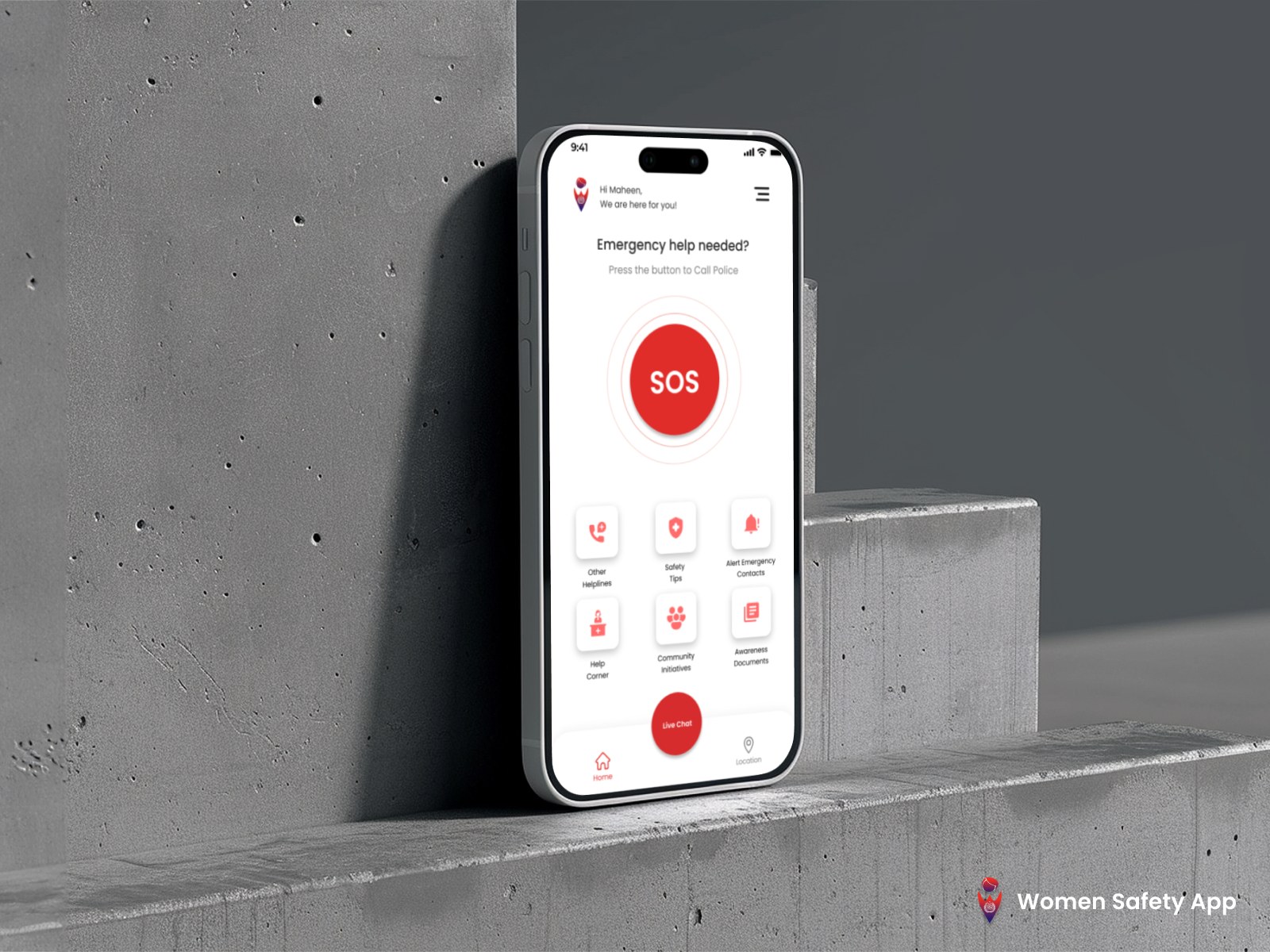 The app home screen on a phone resting against a concrete wall